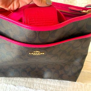 Brown Coach bag with dark pink trim.